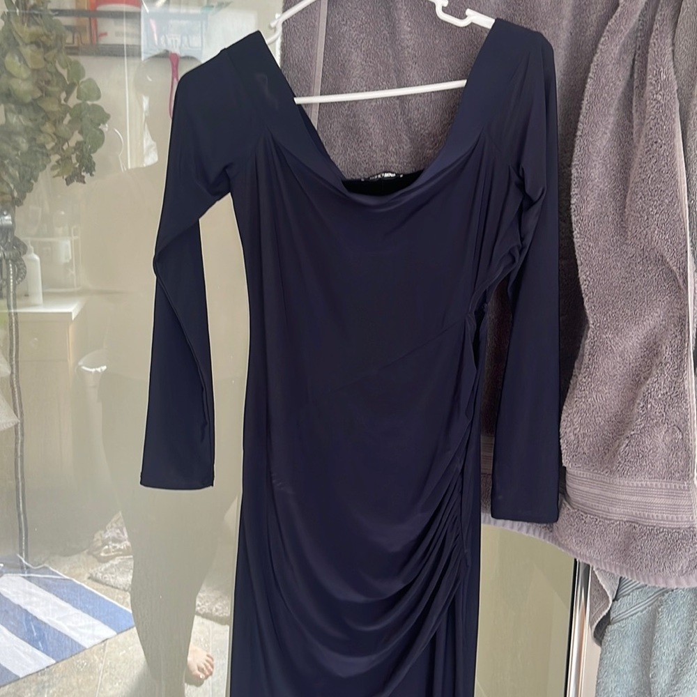 Navy blue king dress that has a slit and opens at the knee.